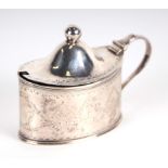 A George III silver mustard pot of navette form with scroll handle and chased decoration, London