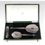 A late 20th century silver three-piece dressing table set, Birmingham 1990, retailed by Harrods