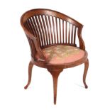 An Edwardian mahogany slat back tub chair with upholstered seat.