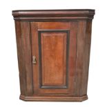 A 19th century oak wall hanging corner cupboard.