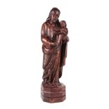 A 19th century carved hardwood group of Joseph holding the baby Jesus, with vestiges of old gesso
