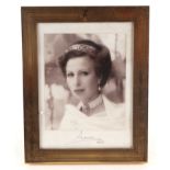 A photograph of Princess Anne with facsimile signature and dated 1987, in a gilt metal strut frame