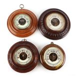 An aneroid wall barometer in a carved oak case, 21cm diameter; and three similar (4).