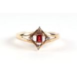 A 9ct gold red stone and diamond ring, the central emerald cut red stone flanked by four small