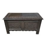 A Victorian Edwards & Roberts 17th century style oak coffer with candle box and carved decoration,