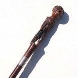 A 19th century mahogany walking stick with figural handle depicting a young boy wearing ragged