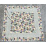 A large fabric bed quilt with geometric design, 270cm by 255cm