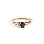 A 9ct gold sapphire and diamond ring, the central sapphire flanked by diamonds, approx UK size '