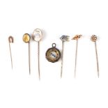 A 9ct gold horseshoe stick pin; together with five other stick pins and a fob compass (7).