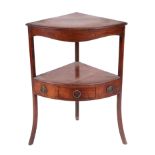 A George III mahogany corner washstand with solid top above an under-tier and three drawers, on a