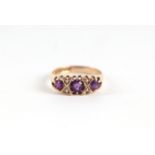 A 9ct gold three stone amethyst and seed pearl half hoop ring, approx UK size 'M', 2g.