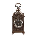 A brass lantern style carriage clock with enamel Arabic numerals, the brass movement striking on a