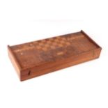 A specimen wood backgammon, chess and other games board, 55cms wide.