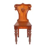 A Victorian oak hall chair with shield shaped back, solid seat and turned front legs.