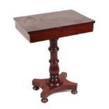 A Victorian mahogany work table, the rectangular hinged top enclosing a fitted interior, on turned