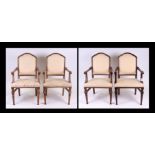 A set of four beech elbow chairs with upholstered seats and backs (4).
