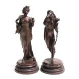 A matched pair of bronzed figures depicting a young man and a young woman, 27cms high (2).