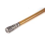A rhino horn riding crop or swagger stick with Chinese embossed silver coloured metal pommel, 83cm
