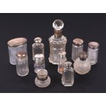 A quantity of silver topped and silver mounted dressing table jars and scent bottles.