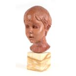 Fiore de Henriquez (Italian 1921-2004) - a clay bust of a young boy, mounted on a figured marble
