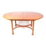 An Ercol elm oval extending dining table on turned legs with shaped stretcher, 108cm by 162cm not