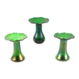 Three Favrile style iridescent green vases, each 12cms high (3).