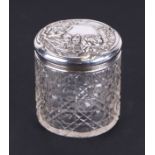 An Edwardian cut glass and silver topped cosmetic jar with repoussé floral decoration, Birmingham