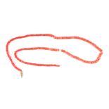 A salmon pink coral bead necklace, 72cms long, 44g.