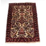 A Persian style prayer rug with stylised flowers and birds within a multi border, on a cream ground,