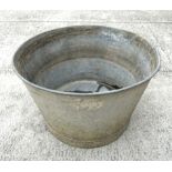 A large two-handled galvanised metal pail or washtub, 53cm diameter.