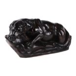 A bronzed resin figure of a crouching lioness on a rocky base, signed 'J. Lee', 46cm wide.