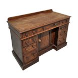 A Victorian mahogany kneehole desk with an arrangement of nine drawers and central cupboard, on a