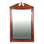 A 19th century mahogany wall mirror with broken arch pediment and bevelled rectangular glass