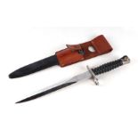 A Swiss M1957 Schmidt Rubin bayonet for the STGW 57, in its scabbard with leather frog. Makers