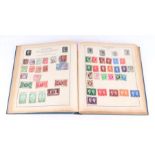 A Strand stamp album containing World and GB stamps including Penny Reds, Canadian, India, Japan,