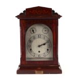 An Edwardian mantle clock, the silvered dial with Arabic numerals and German movement, in an