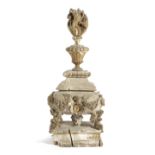 An 18th century carved wood reliquary, the central relic surrounded by cherubs and floral swags,