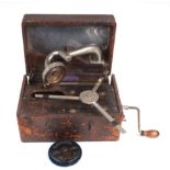 A 'Carrie Dot' portable Gramophone with three-spoke turntable and captive hinged horn lid in a