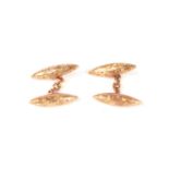 A pair of late 19th century 9ct gold cufflinks with engraved decoration. 4.2g