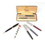 A group of vintage fountain pens to include Watermans and Parker; together with a novelty propelling