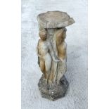 A weathered reconstituted stone pedestal depicting the three graces. Condition Report There are