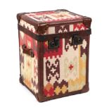 A leather and brass mounted trunk covered in kilim material, the locks stamped Bond Street London,