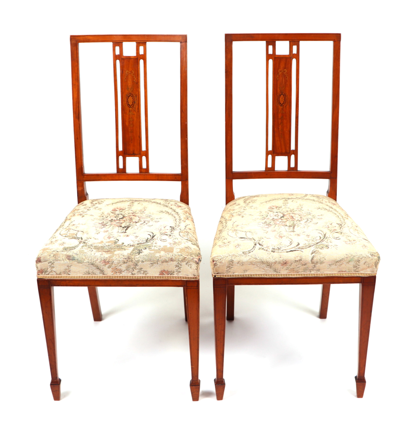 A pair of late 19th century inlaid satinwood occasional chairs with upholstered seats, on square