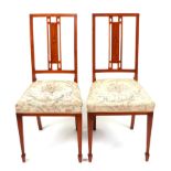 A pair of late 19th century inlaid satinwood occasional chairs with upholstered seats, on square