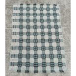 A Welsh woollen blanket with geometric design on a blue ground, 154cm by 220cm.