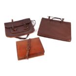 Three vintage leather satchels.