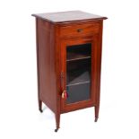 An Edwardian inlaid mahogany cabinet with single frieze drawer above a glazed door enclosing a