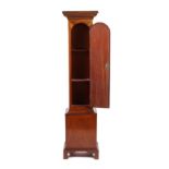 A mahogany pedestal stand in the form of the lower half of a dwarf longcase clock, the single door