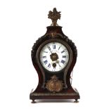 A 19th century French mantle clock, the white porcelain dial with Roman and Arabic numerals,