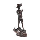 After Ernest Rancoulat, a bronzed spelter figure of a young boy holding a fish and wearing a